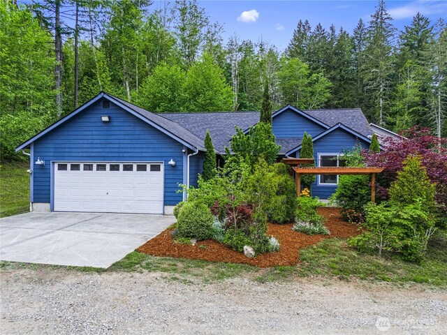 18514 71st St NW, Vaughn, WA 98394 - view of front of property with concrete driveway, an attached garage, and a shingled roof