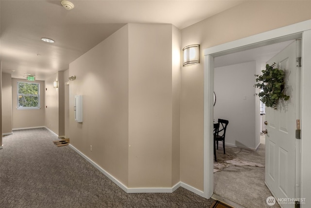 hall with baseboards and carpet