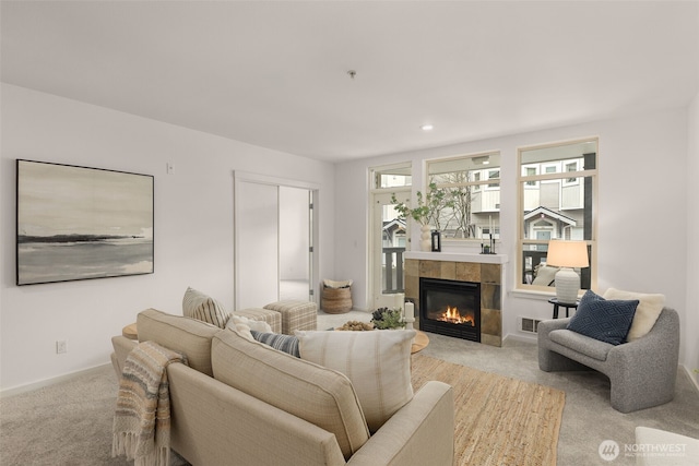 living room featuring a fireplace, carpet, recessed lighting, baseboards, and visible vents