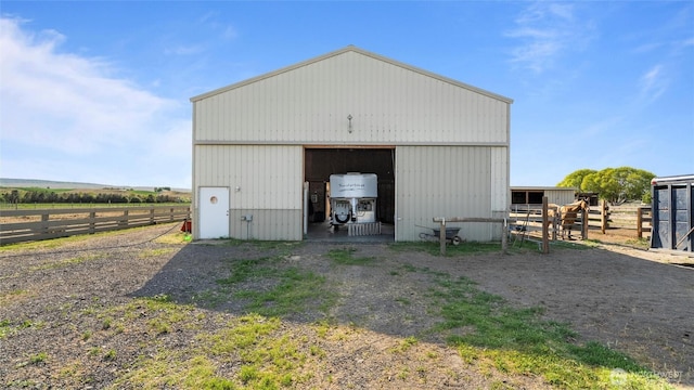 view of pole building with fence
