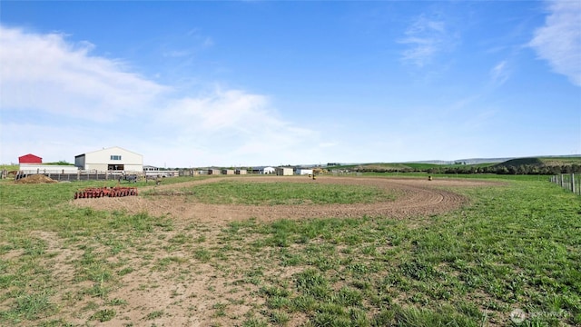 view of yard with a rural view and fence