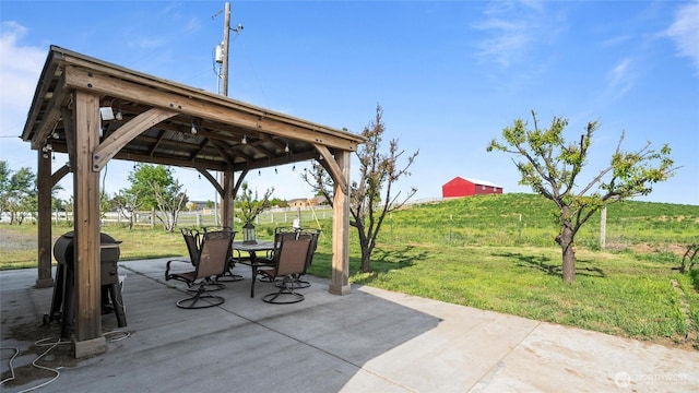 view of patio with outdoor dining area and a gazebo