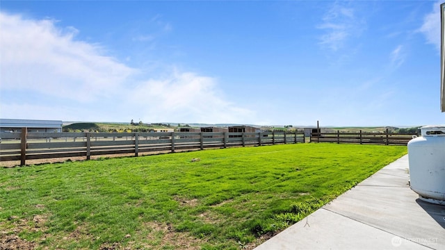 view of yard with a rural view and fence