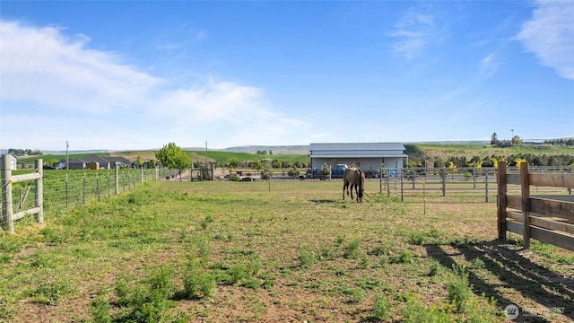 view of yard featuring fence and a rural view