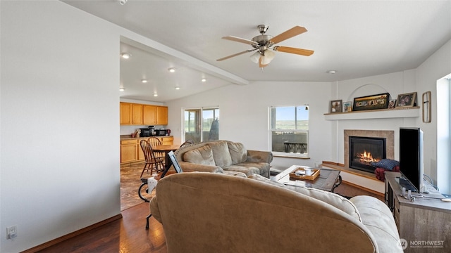 living room with a ceiling fan, a fireplace, baseboards, dark wood-style floors, and lofted ceiling with beams