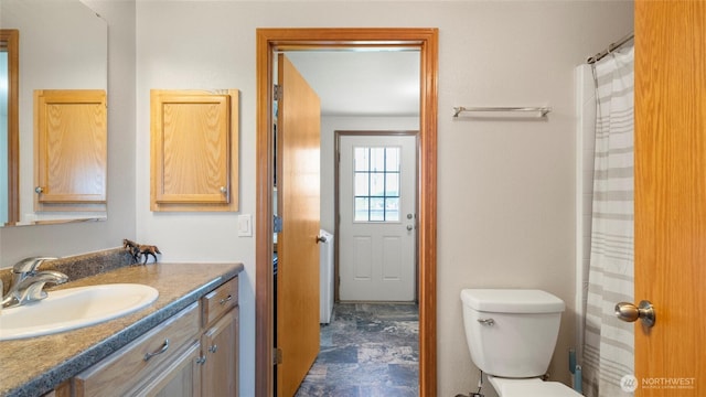 bathroom with toilet and vanity