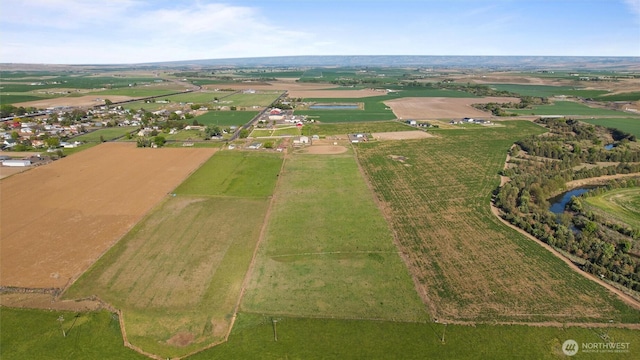 birds eye view of property with a water view and a rural view