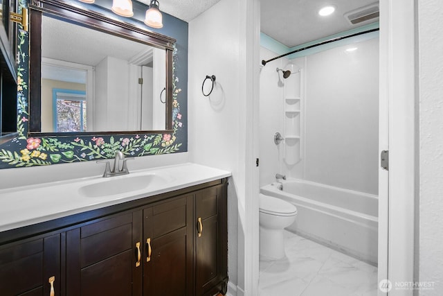 full bath featuring a textured ceiling, vanity, toilet,  shower combination, and marble finish floor
