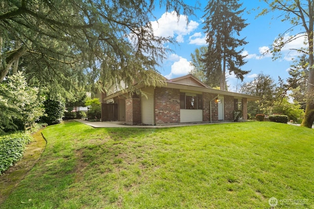 exterior space featuring brick siding and a lawn