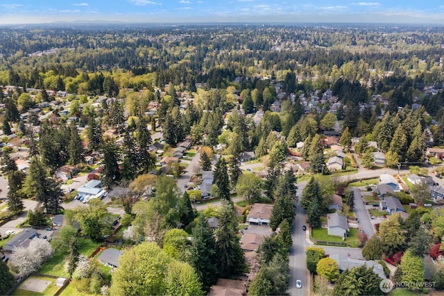 birds eye view of property featuring a residential view and a wooded view