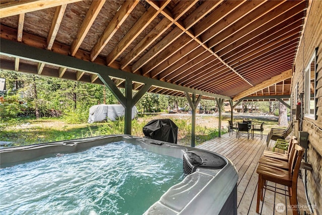 wooden terrace with a grill and a hot tub