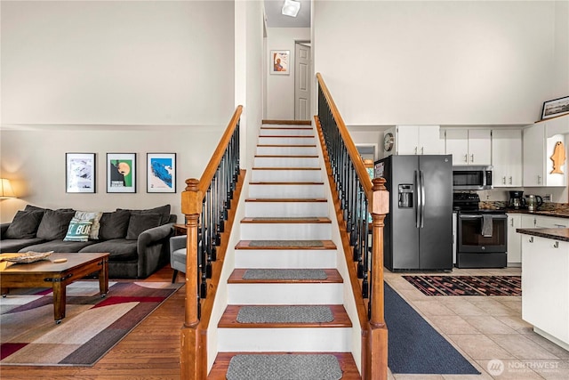 staircase with a high ceiling