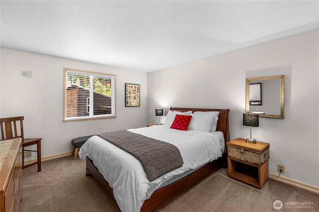 bedroom with carpet floors and baseboards