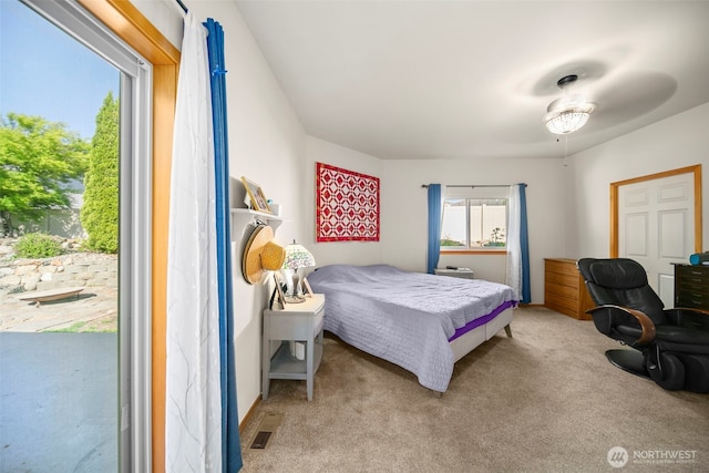 bedroom featuring light carpet, access to outside, and visible vents