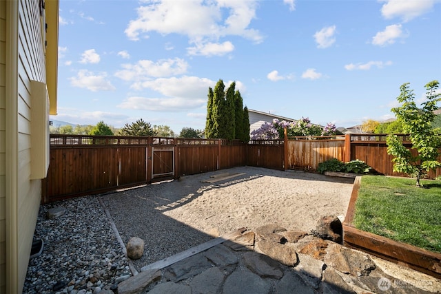 view of yard with a patio, a gate, and fence private yard