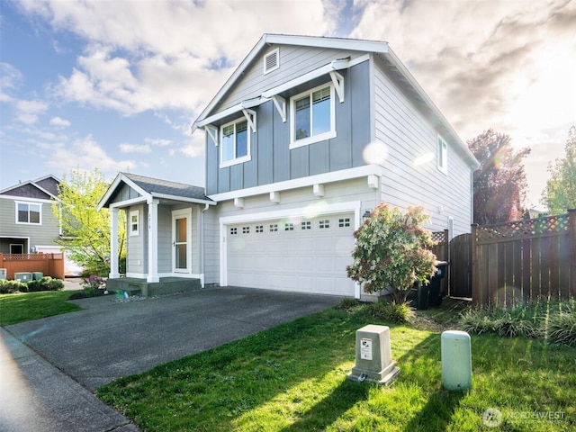 traditional-style home with board and batten siding, a front yard, fence, concrete driveway, and an attached garage