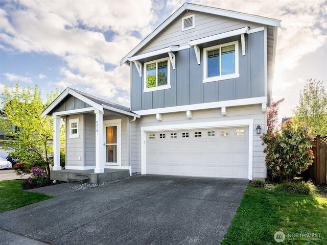 traditional-style house featuring a garage, fence, board and batten siding, and driveway