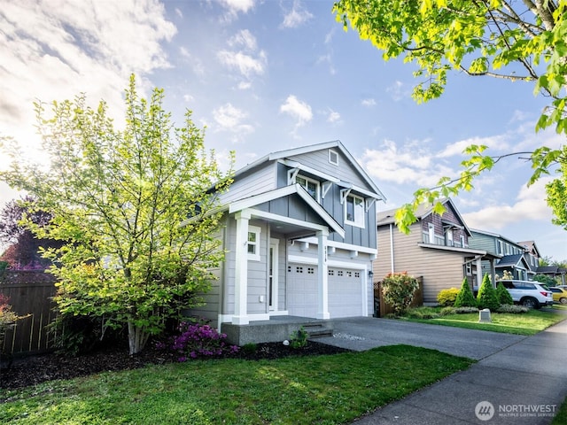 view of front facade with board and batten siding, a garage, a front yard, and aphalt driveway
