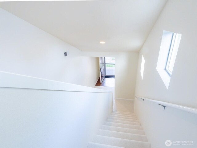 staircase featuring recessed lighting