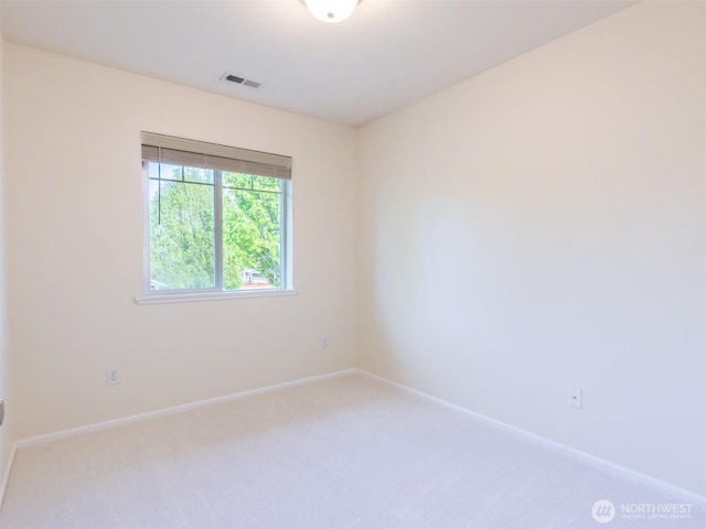 unfurnished room featuring baseboards, carpet, and visible vents