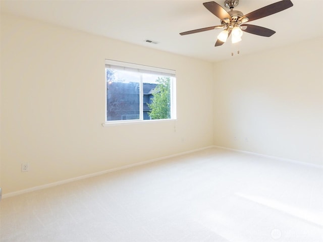 unfurnished room with visible vents, a ceiling fan, baseboards, and light carpet