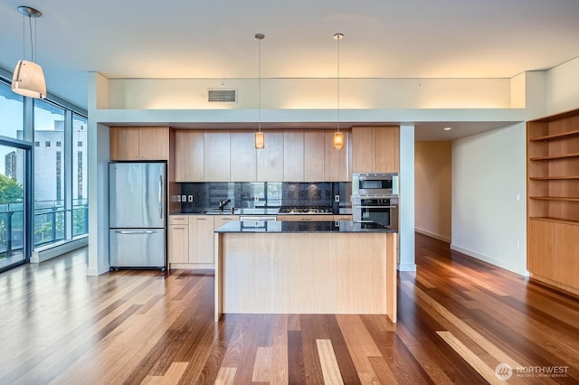 909 5th Ave Unit 701, Seattle, WA 98104 - kitchen featuring a sink, visible vents, dark wood-style flooring, appliances with stainless steel finishes, and tasteful backsplash