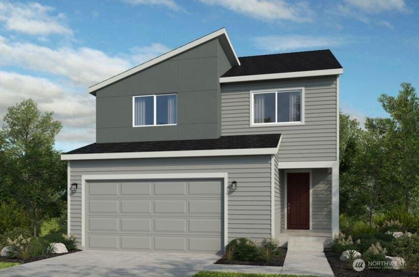 view of front of home featuring roof with shingles, an attached garage, and driveway