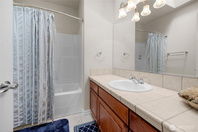 bathroom featuring tile patterned floors, vanity, a chandelier, and shower / bath combination with curtain