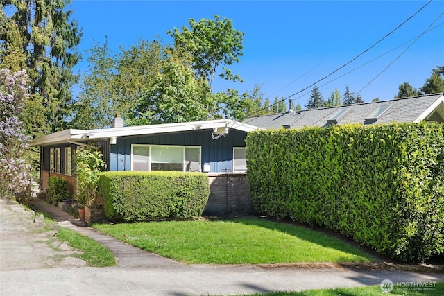 812 N 59th St, Seattle, WA 98103 - view of front of property with a chimney, board and batten siding, brick siding, and a front yard