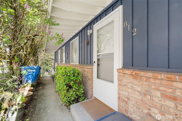 812 N 59th St, Seattle, WA 98103 - view of exterior entry featuring brick siding and board and batten siding