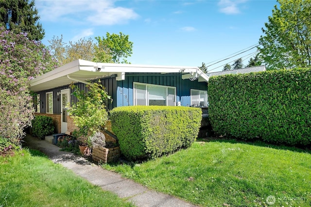 812 N 59th St, Seattle, WA 98103 - view of front of house featuring a front lawn and board and batten siding