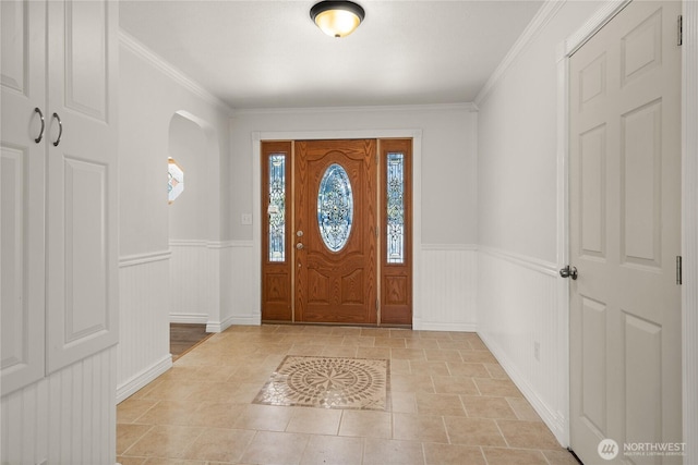 7295 Navajo Trl NE, Bremerton, WA 98311 - entrance foyer with a wainscoted wall, ornamental molding, and arched walkways