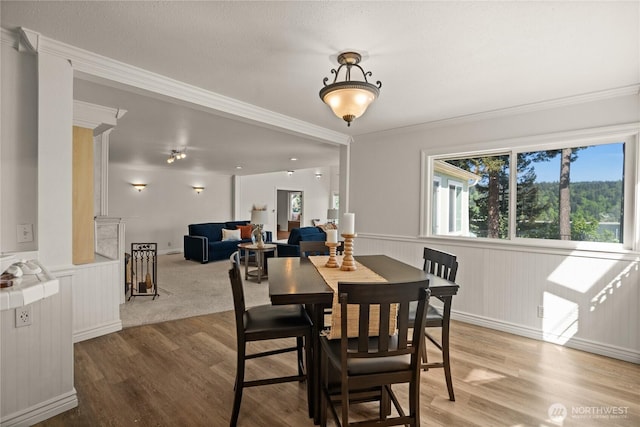 7295 Navajo Trl NE, Bremerton, WA 98311 - dining area featuring wood finished floors, wainscoting, and ornamental molding