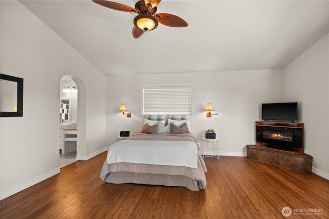7295 Navajo Trl NE, Bremerton, WA 98311 - bedroom featuring vaulted ceiling, wood finished floors, arched walkways, baseboards, and ceiling fan
