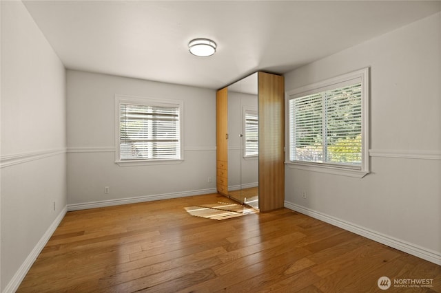 7295 Navajo Trl NE, Bremerton, WA 98311 - unfurnished bedroom with wood-type flooring and baseboards