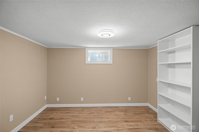 7295 Navajo Trl NE, Bremerton, WA 98311 - basement featuring wood finished floors, a textured ceiling, baseboards, and ornamental molding