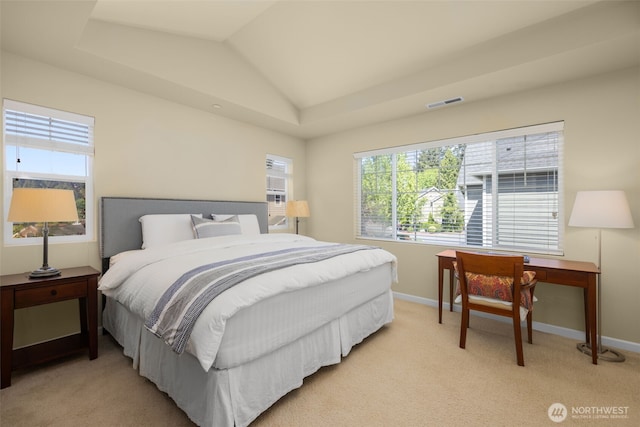 bedroom with light colored carpet, baseboards, and lofted ceiling