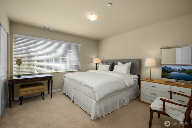 bedroom featuring light colored carpet and baseboards