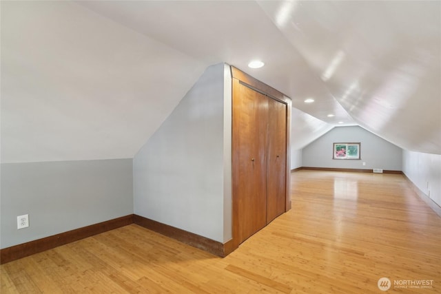 bonus room with lofted ceiling, light wood-type flooring, baseboards, and recessed lighting