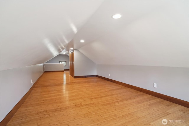 bonus room featuring lofted ceiling, light wood-style flooring, recessed lighting, and baseboards
