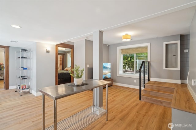 interior space with light wood-style flooring, baseboards, stairs, and recessed lighting