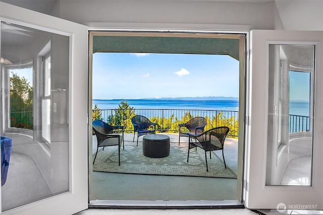 doorway to outside with a water view