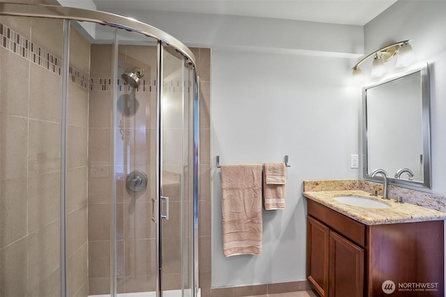 full bathroom with vanity and a stall shower