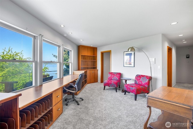 office with light colored carpet, recessed lighting, and built in desk