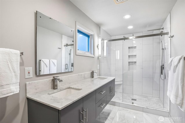bathroom with a sink, a shower stall, recessed lighting, and double vanity