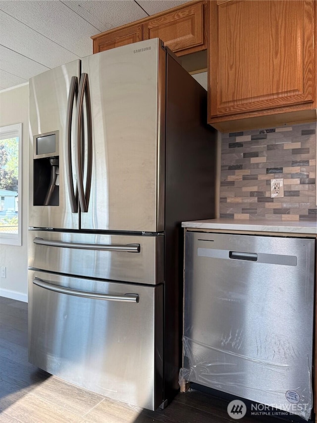 2021 Mahan Ave Unit E3, Richland, WA 99354 - kitchen with wood finished floors, light countertops, brown cabinets, tasteful backsplash, and stainless steel appliances