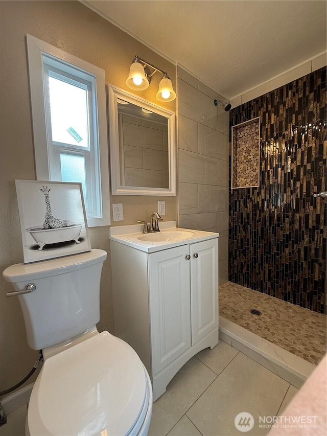 2021 Mahan Ave Unit E3, Richland, WA 99354 - bathroom with toilet, tile patterned floors, tiled shower, and vanity