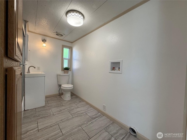 2021 Mahan Ave Unit E3, Richland, WA 99354 - half bathroom with a textured ceiling, crown molding, vanity, baseboards, and toilet