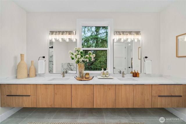 full bathroom with double vanity, a sink, and tile patterned flooring