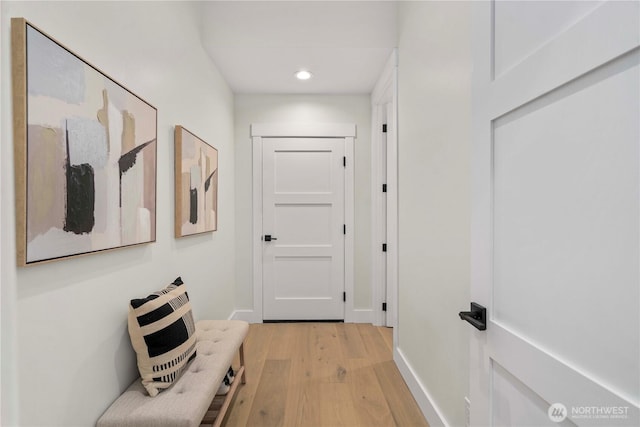 hall with recessed lighting, light wood-style flooring, and baseboards